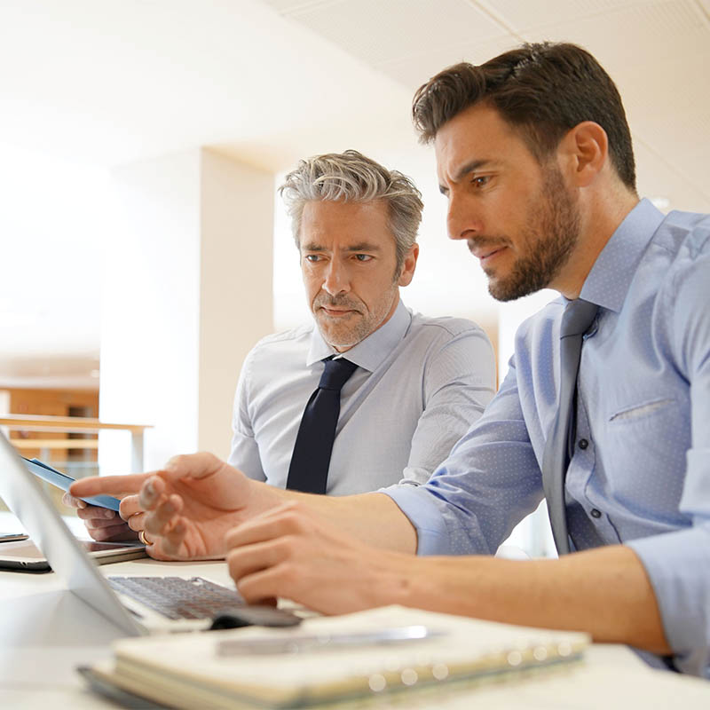 Male coworkers discussing business strategies Male coworkers discussing business strategies